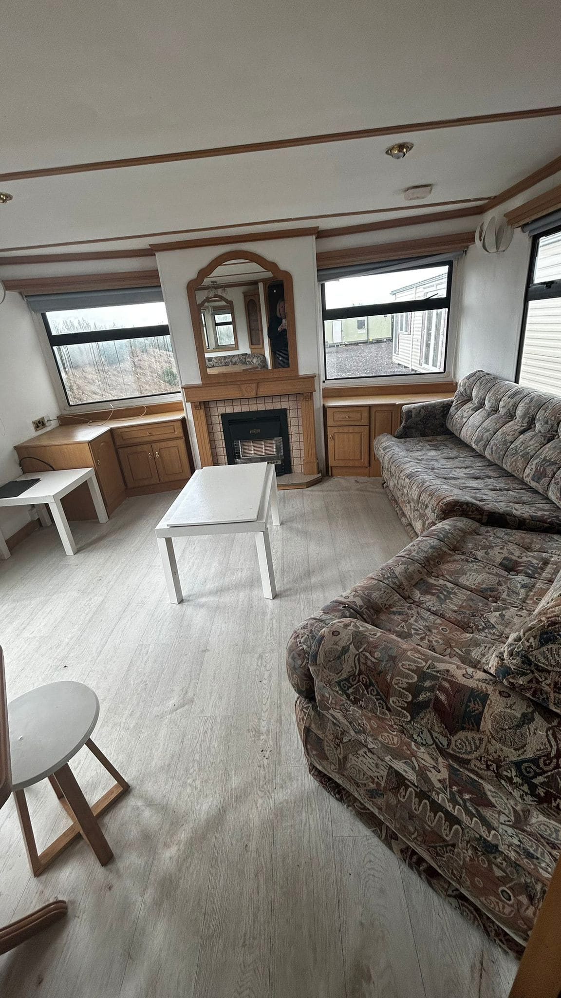 fireplace with mirror and two sofas in lounge Static Caravan.